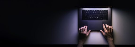Minimalistic workplace, working with computer, using laptop at night and online privacy concept. Web banner with copy space.